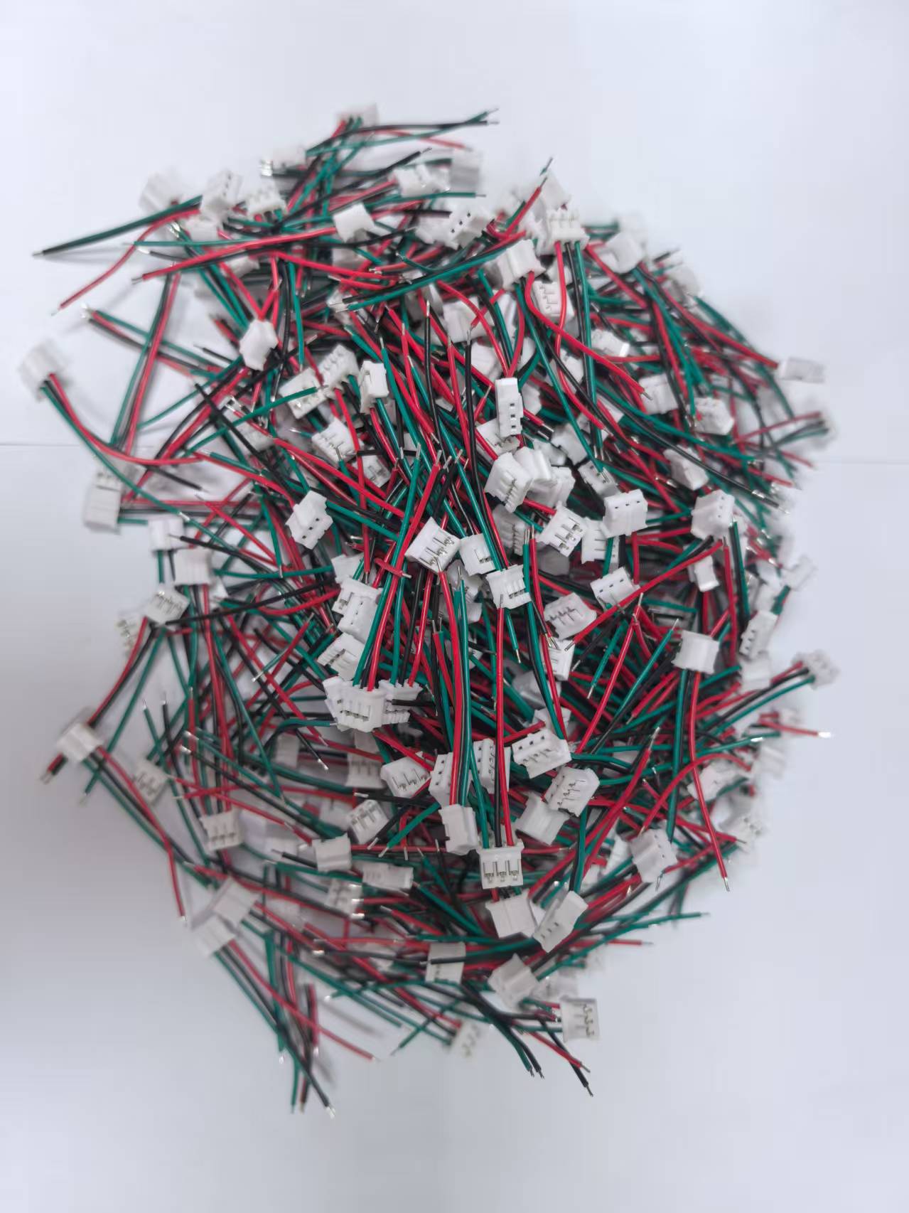 Complex electronic wire harness assembly showing multiple colored wires bundled together with protective sleeves and various connection points